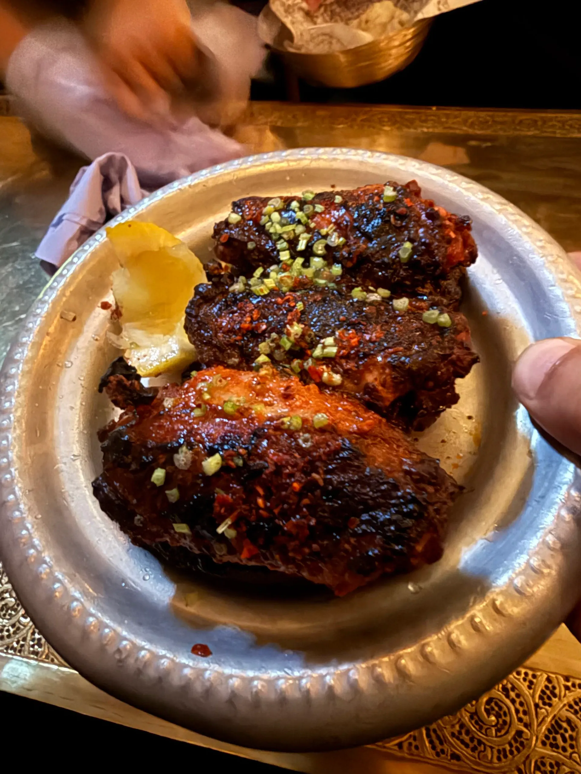 Charcoal-grilled kebabs with a charred lemon served at Berenjak in Soho