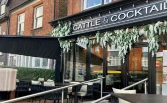 The elegant black facade of Cattle & Cocktail in Oxted