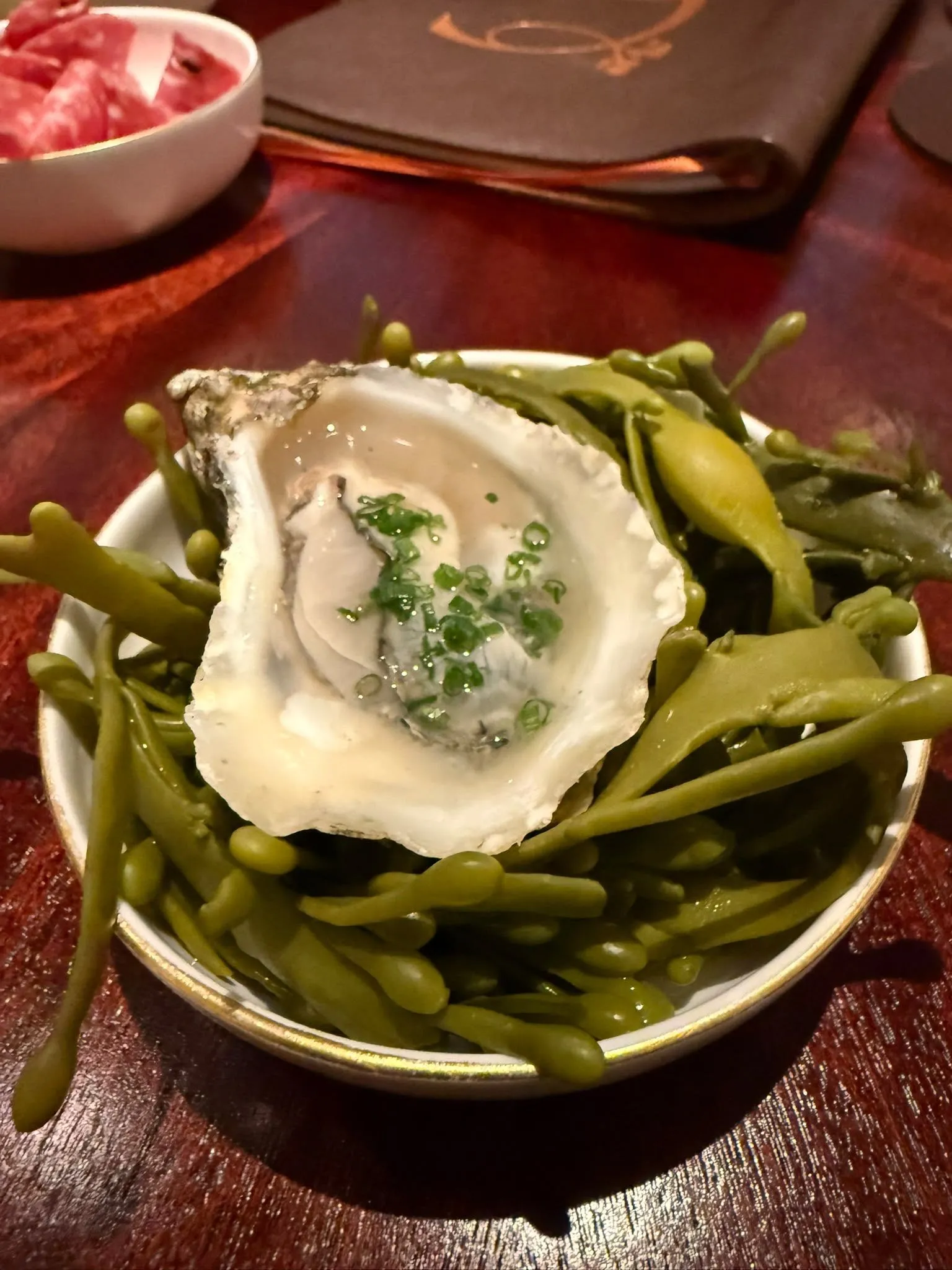 A dressed oyster served over samphire at Corenucopia in Chelsea
