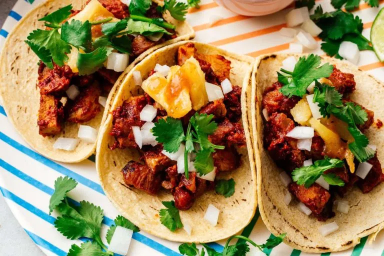 Colourful tacos with pineapple, coriander and onion at El Pastor Soho