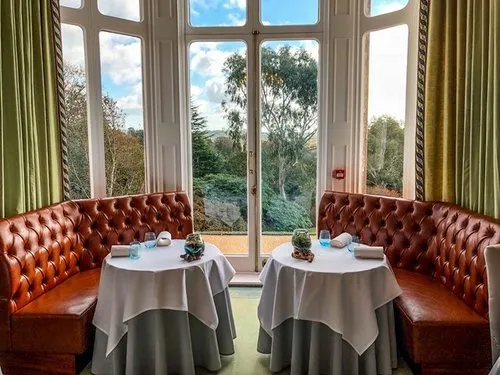 A warmly lit table overlooking the grounds at Restaurant Interlude