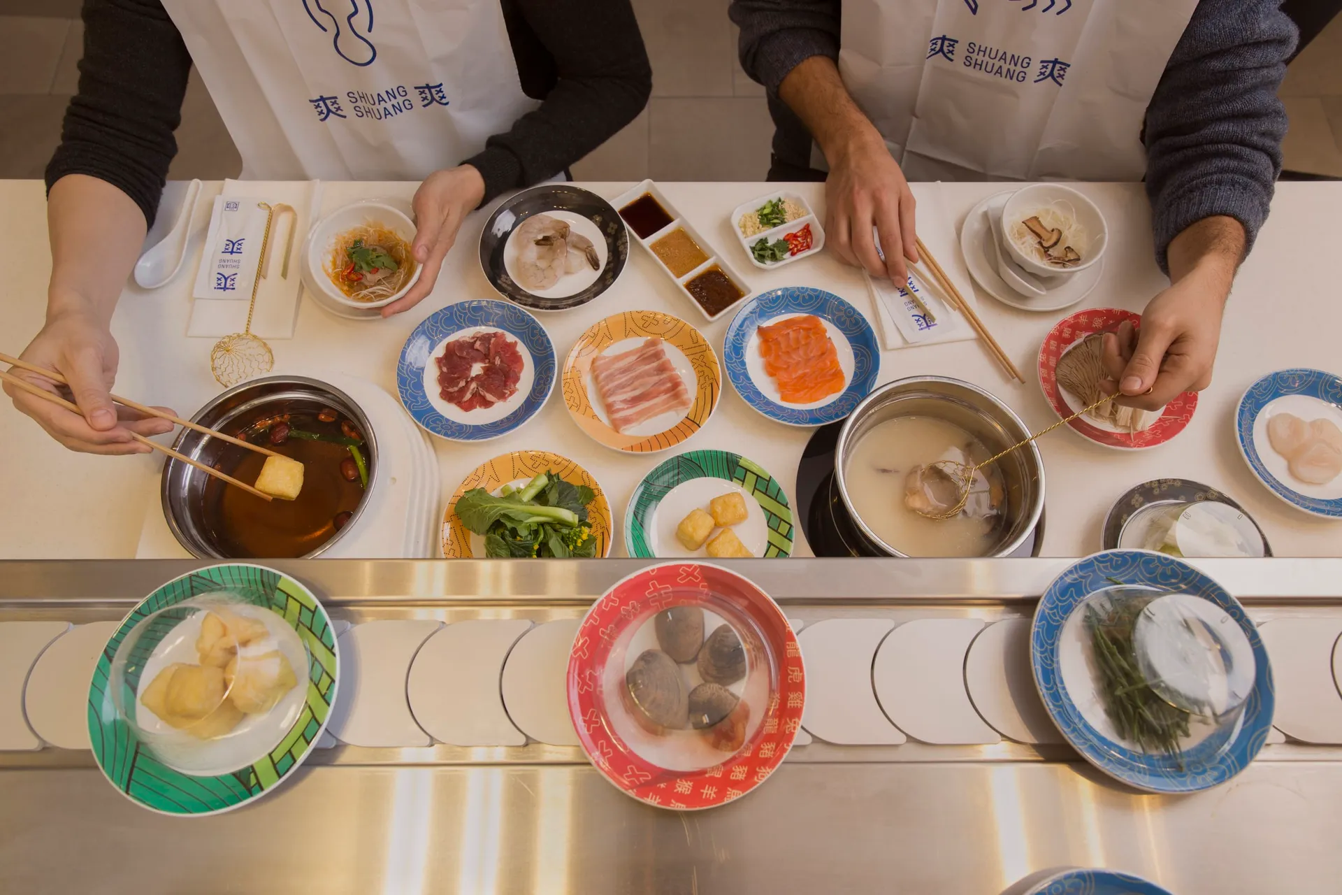 A shared hotpot table at Shuang Shuang