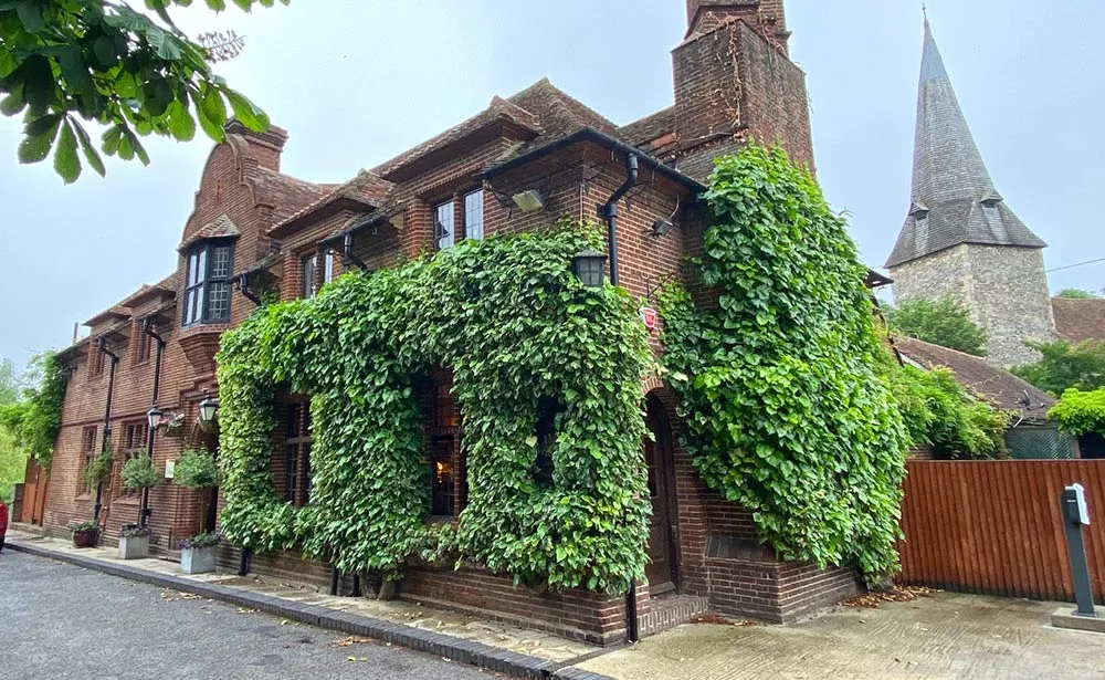 The ivy-covered exterior of The Fordwich Arms beside the church in Kent