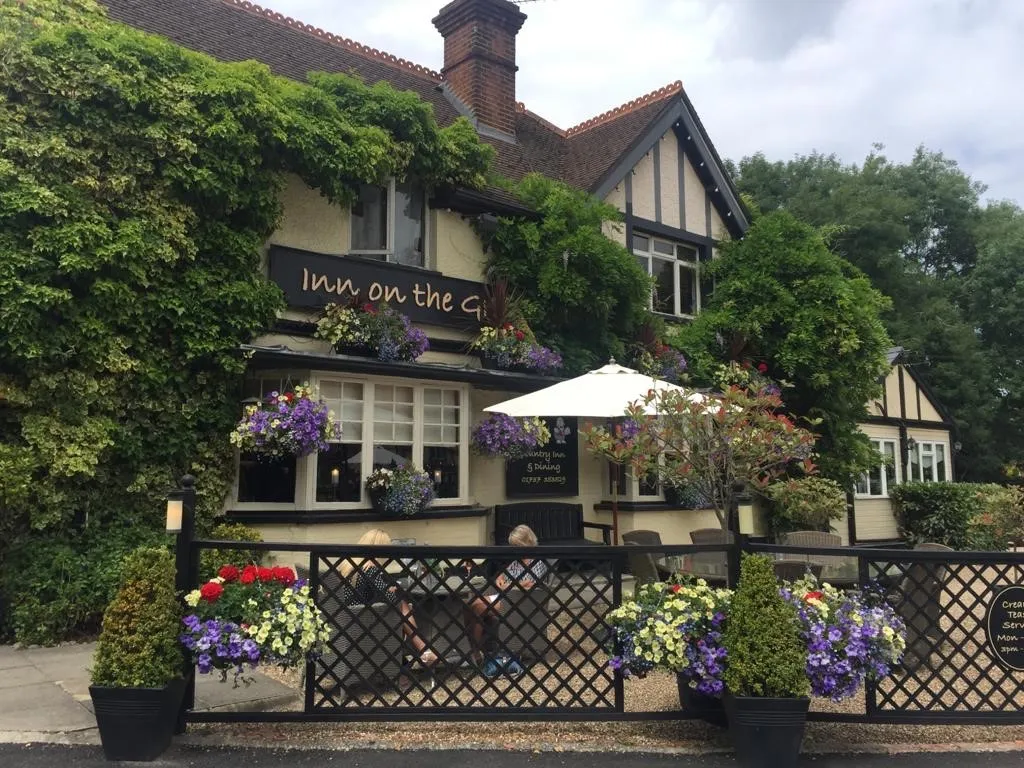 The ivy-covered country inn exterior of The Grumpy Mole in Tadworth